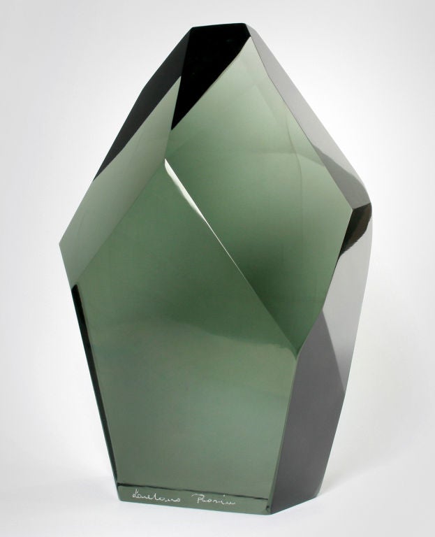 This is a monolithic sculpture, the cut planes of the solid piece of glass refract the light.  Very handsome
