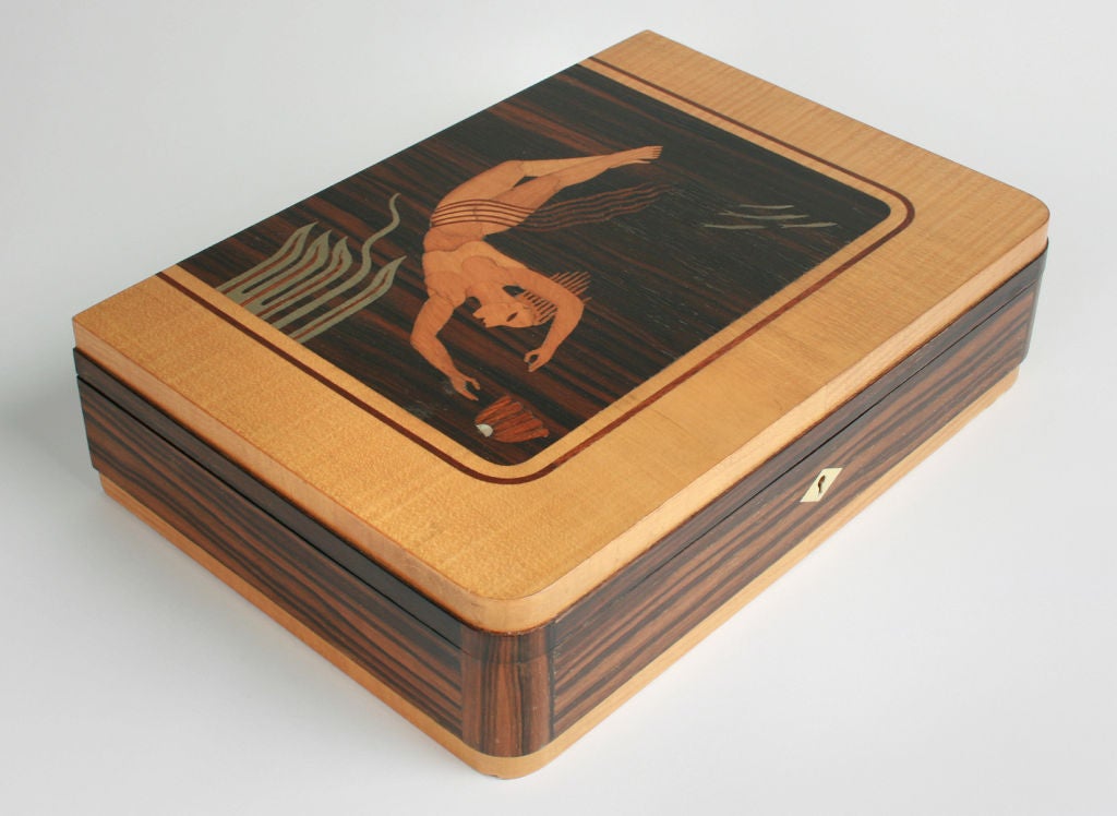 This box is beautifully rendered and inlaid with exotic woods and mother of pearl.
