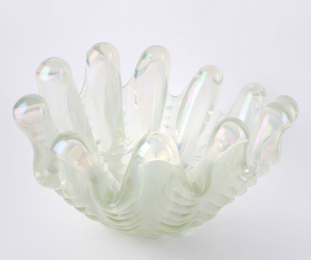This is a fabulous piece of sculptural glass. It is iridescent and comes alive in the light. I believe this is the largest of the series.