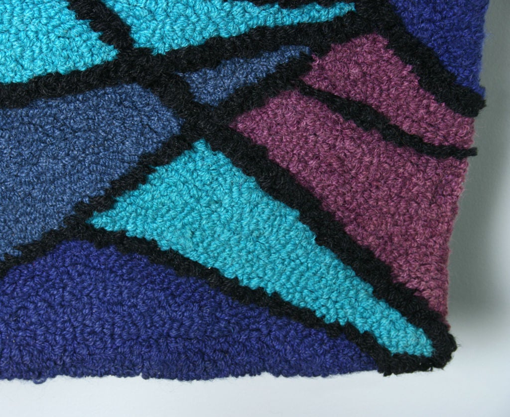This hooked rug has great color and a strong design.