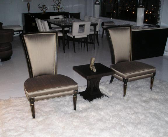 Pair of Jansen style slipper chairs with tall backs and modernized Louis X1V style legs, Ebony frames with gilt highlights. Bronze silk upholstery.