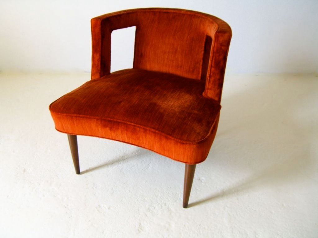 Slipper chair with cut out design in back, tapered wood legs, vintage upholstery