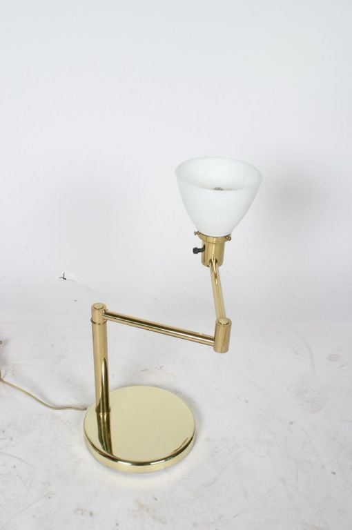 Pair of brass swing arm table lamps by Nessen.