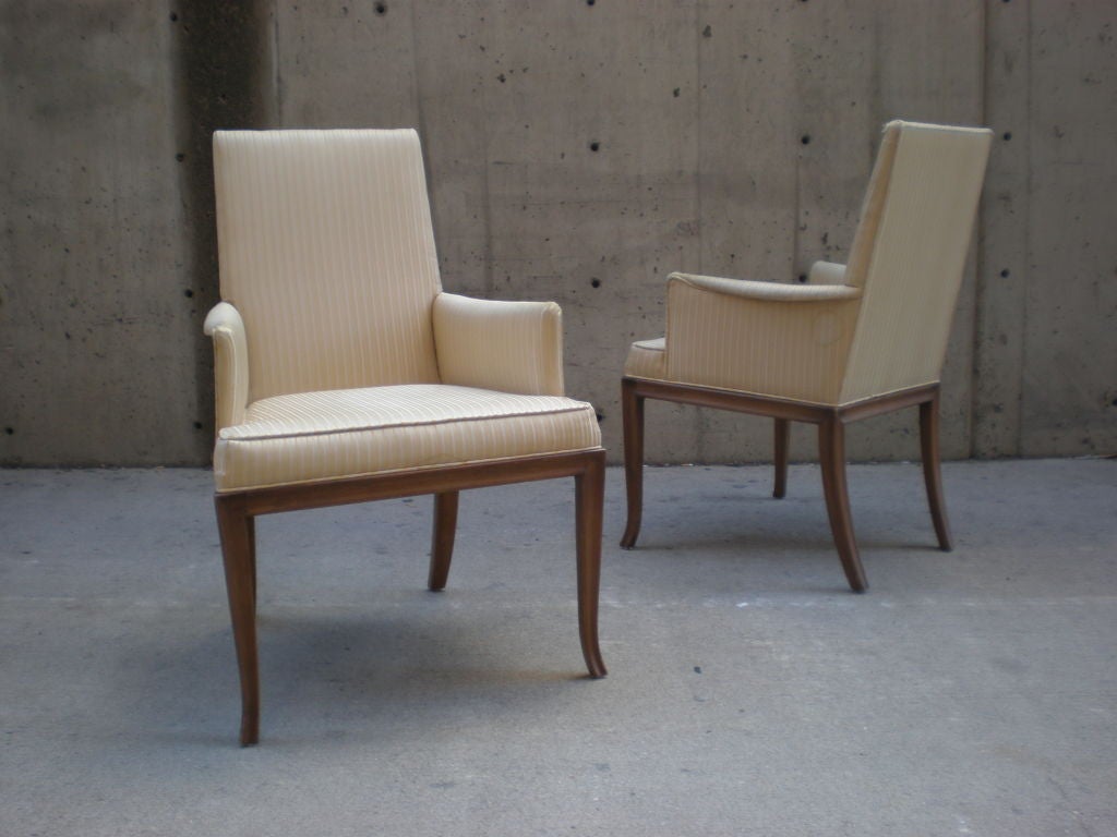 Rare set of 8 T.H. Robsjohn Gibbings dining chairs for Baker. Model number 730. This line of furniture was only offered for a single year. The chairs have elegant splayed, channeled legs that reflect Gibbings interest in mixing modern design with an