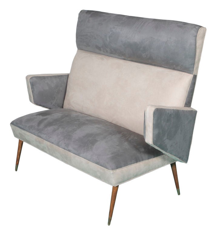 A terrific three-piece midcentury suite including a settee and two armchairs with wood legs. All have been re-upholstered in two-toned grey suede. Purchased in Argentina but probably Italian.

Dimensions: Settee 51 x 43 x 29 inches / chairs each