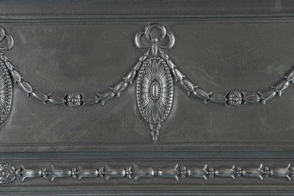 An English, Victorian style cast iron fireplace surround.<br />
<br />
Opening Dimensions:  38