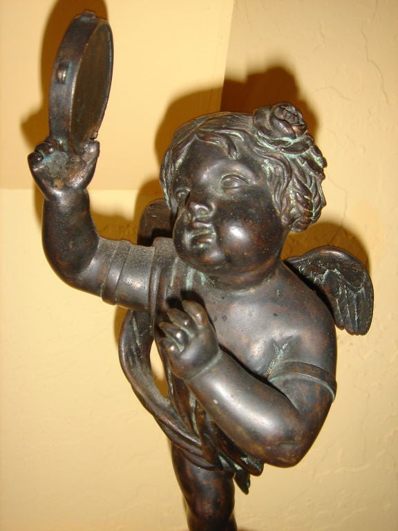 Wonderfully made Pair of French Putti/Cupids each holding a musical instrument (flutes & tambourin) having roses in their hair signed AB with heavy rouge (reddish) marble bases (note the old screw to each base. Well executed.