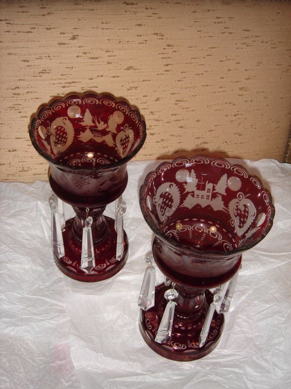 Bohemian Ruby glass cut-to-clear lusters with scalloped edge rim, baluster form stem, circular foot with crystal drops.