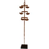 African Iron Sculpture "Man sitting atop 5 cups"