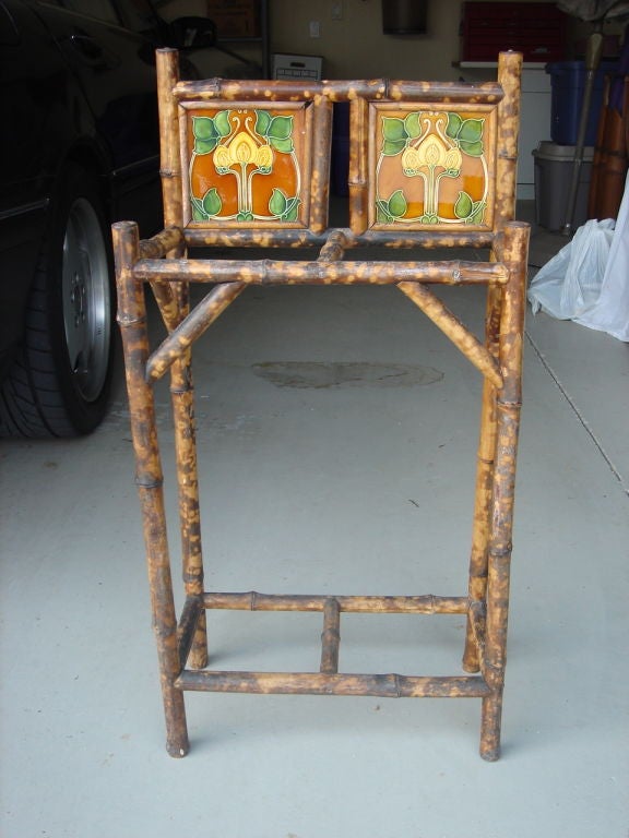 Bamboo Plant Stand/Umbrella Holder/Towel Rack, with two (2) William Morris tiles in the top section. Tiles have deep yellow flower and leaf green design on dark honey background.