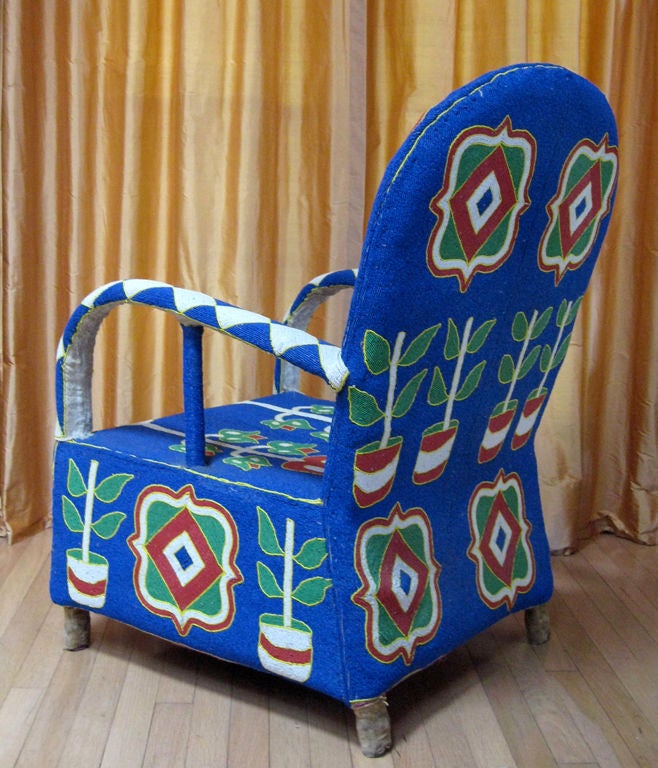 A whimsical club chair entirely covered with vibrant glass beadwork. The condition, colors and designs of this particular chair make it very desirable.