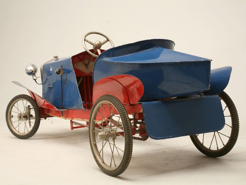 Fiat pedal car modeled after the boattail Fiat c.1917 and we're guessing this was made in the 20's or 30's. This toy car is a pedal car with double chain drive, coil springs on rear axle and has an actual brake drum. The lever on the right hand side