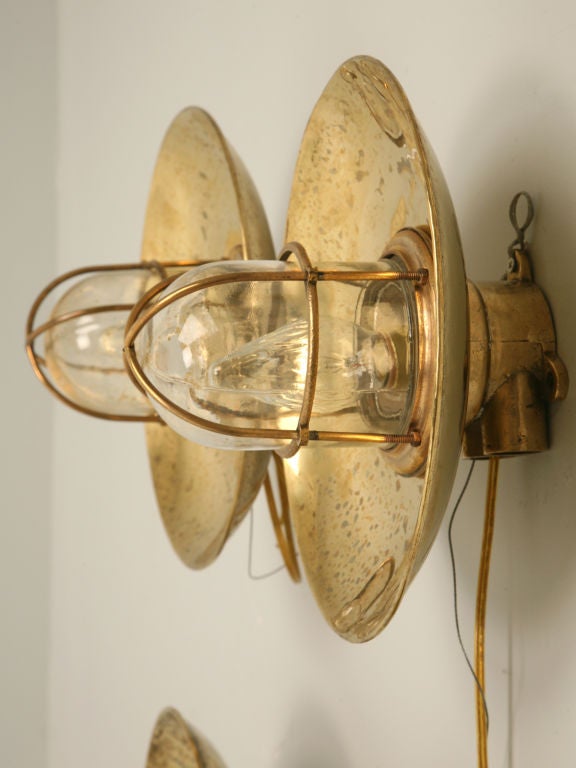 These are being sold separately. Solid brass light fixtures with hand-blown thick glass globes. They originally belonged to a ship and can be used on either the wall or ceiling. Our best guess is that these lights are from the 20's or 30's but we