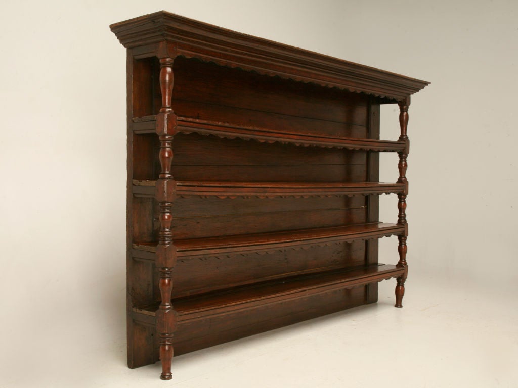 French four shelf plate rack with an oak frame and pine backboards, a scalloped trim, great turnings and its wooden-peg constructed. It still sports very old, if not original, shipping labels on the back (image 10). The depth below is for the crown,