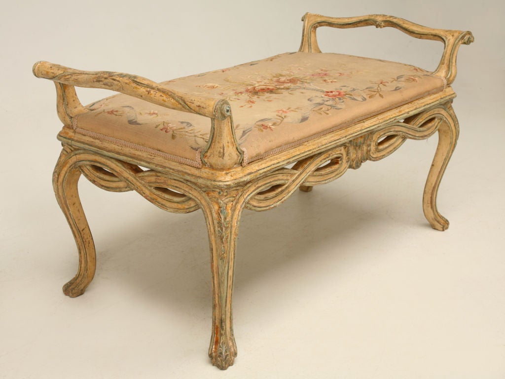 Spectacular 18th century Italian bench with it's original paint and it's original Aubusson upholstered tapestry seat. Perfect utilized at the end of a bed, in the foyer, or even as extra seating in the living room or parlor. This awesome bench