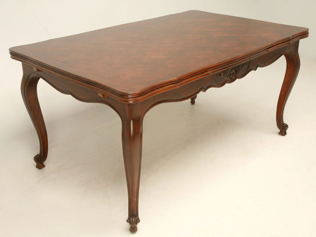 Vintage French cherry draw leaf dining table with a parquet top, a scalloped apron, cabriole legs and escargot feet. <br />
<br />
The table extends to 103.75