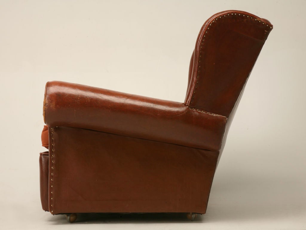 Rare vintage English winged back club chair in its original leather with a new ultrasuede cushion. Extremely comfortable!!!<br />
<br />
The height below is for the highest point which is the wing. The back is 32.5