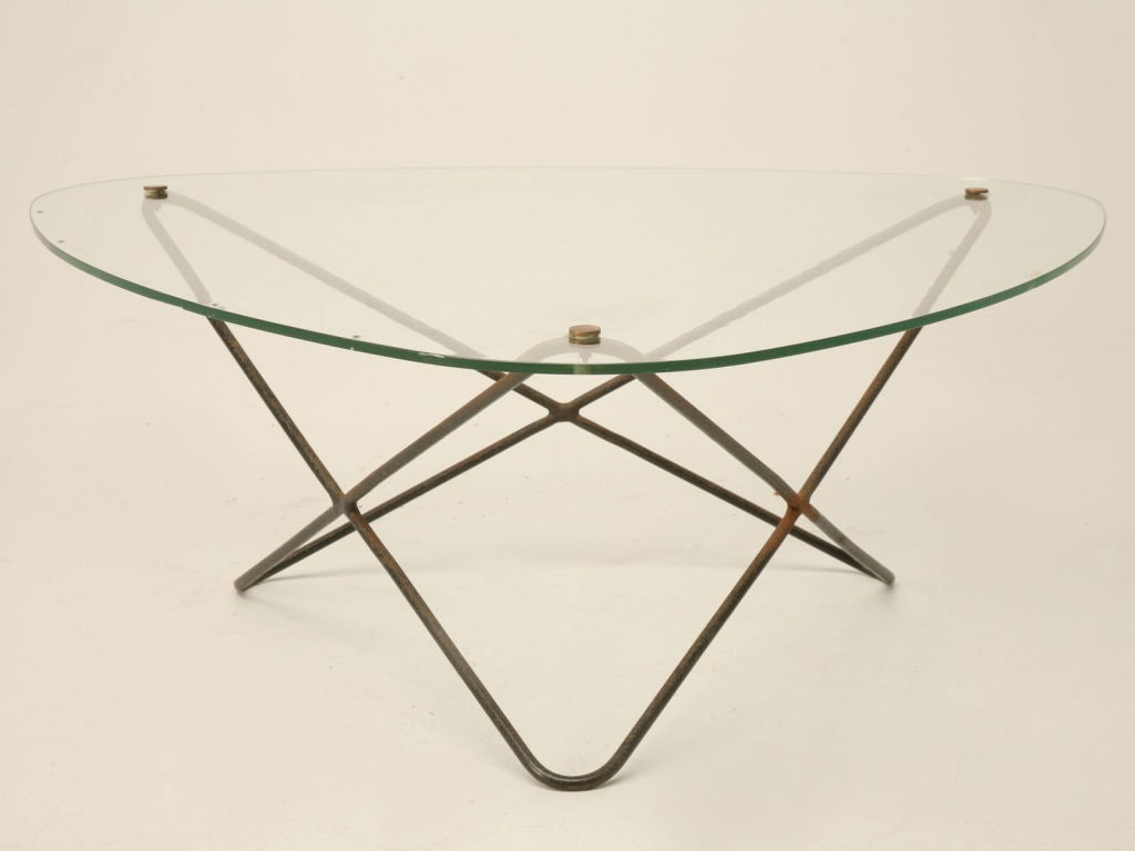 Outstanding vintage French atomic modern coffee table attributed to Pierre Guariche. This coffee table has a black painted steel base with brass fittings and the original glass top- please note the mold marks in the glass (image 5). A fantastic