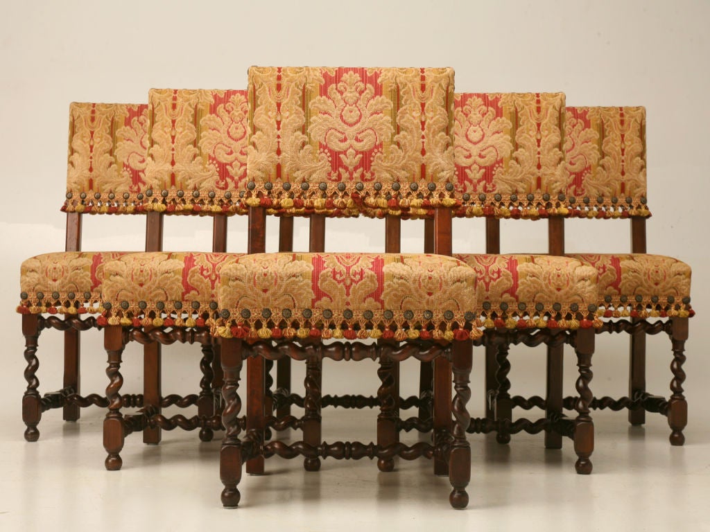 Set of eight French walnut Louis XIII style barley twist dining chairs with hand-carved face detail on the arms and the original horsehair padding.<br />
<br />
* The measurements below are for the side chairs. The armchairs are 36