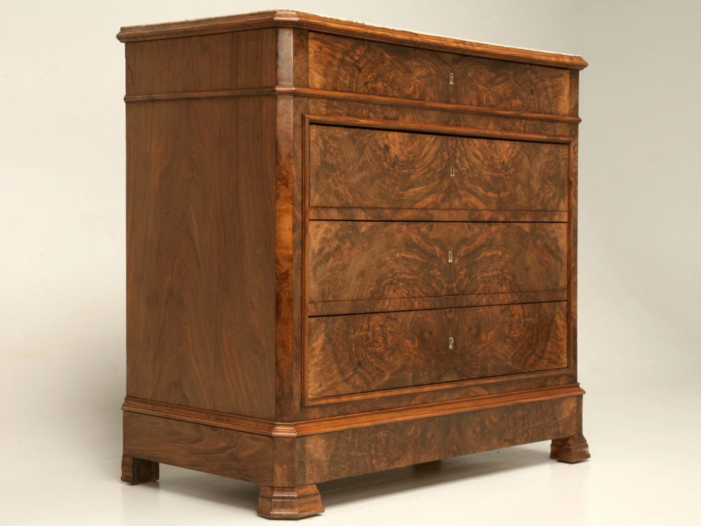 Beautiful antique French book-matched burled walnut 4 drawer Louis Philippe commode. The stunning lines and scale of this particular commode are awesome. This fine piece would add style and grace to a bedroom suite, a welcoming foyer, or even
