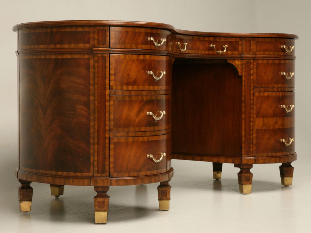 Stunning banded crotch mahogany kidney shaped desk attributed to Maitland-Smith. In very nice condition, this masterpiece not only has a classic kidney shape, but also provides great storage, too. This phenomenal desk would also make an interesting