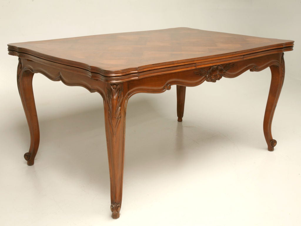 This particular vintage French cherry draw-leaf dining table is dynamite. From it's exquisite parquet scalloped top, wonderful carved aprons, and graceful legs, to it's easy to operate draw-leaf function, this table is fabulous.<br />
<br />
* The