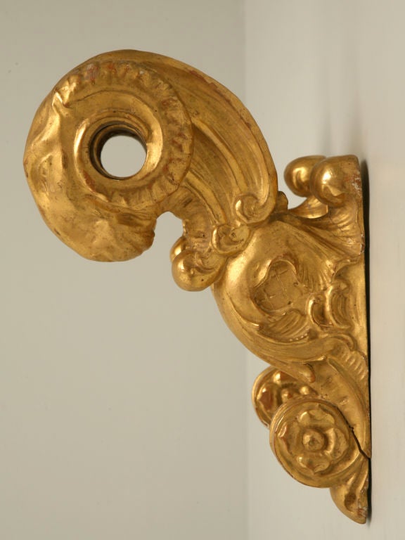 Absolutely incredible pair of all original Italian 24-karat gilded ram pole brackets to either hold a wall hanging or window treatment.