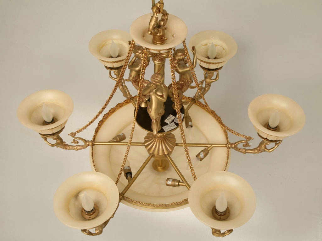 Fabulous large scale twelve light mermaid adorned alabaster chandelier. Although this chandelier isn't that old, it does make quite a statement. Please take note that six of the twelve lights are in the center bowl. Of equal note, we currently have