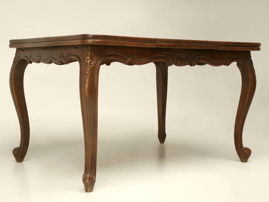 Beautiful vintage French oak draw-leaf dining table. A great petite scale with Classic carvings, make this table well-suited for most any room of the home. The French people utilized these great tables not only in their dining rooms, but also in
