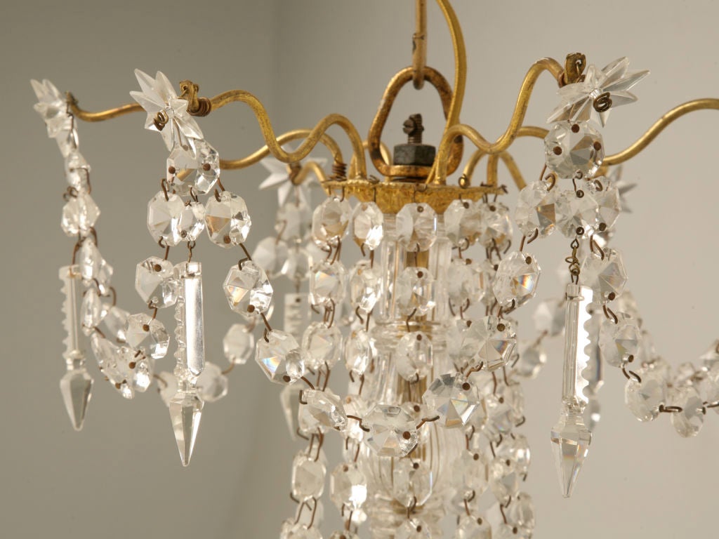 Stunning vintage French crystal 6 light chandelier. This beauty has a fabulous assortment of crystals including stars and spears. This awesome chandelier casts an amazing glow as the high quality crystal reflects and refracts the shimmering light.