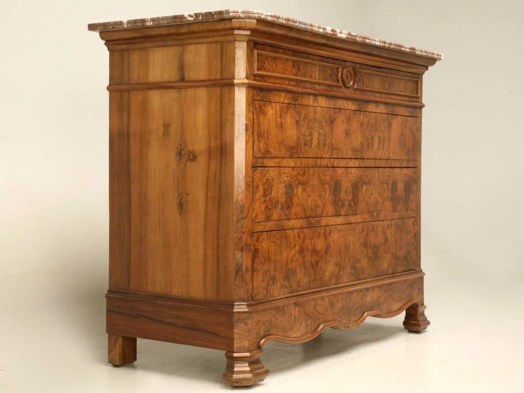 Outrageous antique French Louis Philippe bookmatched burled walnut commode with its original marble top that has ribbed details, an unusual scalloped apron, canted corner details, hand dovetailed drawers and a little bigger than usual overall scale.