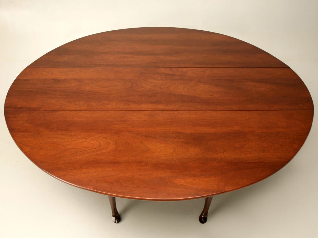 Large vintage English, Queen Anne solid mahogany double-gateleg dining table . This striking table, whether utilized full-time in a dining room or as a secondary table, is actually substantial enough to seat 12 very comfortably. Wonderful behind a