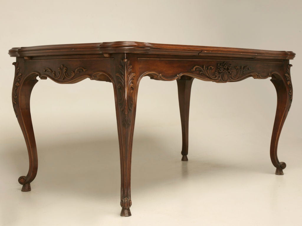 Exceptional vintage walnut draw leaf table with elegant carvings and an outstanding top. <br />
<br />
* The length below does not include the leaves. The length with the leaves extended is 99.75