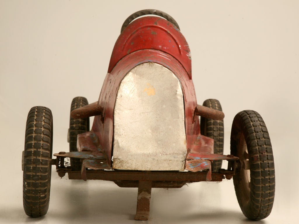 Don't miss this, your opportunity, to delight a child with his or her very own vintage French pedal powered boat-tailed speedster. Don't miss out on this cute lil red hot racer.