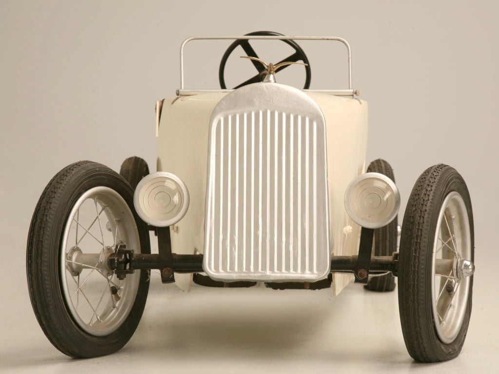 Yippee! We exclaimed, when we found this awesome unrestored English 40's bentwood roadster pedal car. A dynamite prop or a perfect toy for that special child in your life, this great pedal-car is a one-of-a-kind treasure, in fantastic condition.