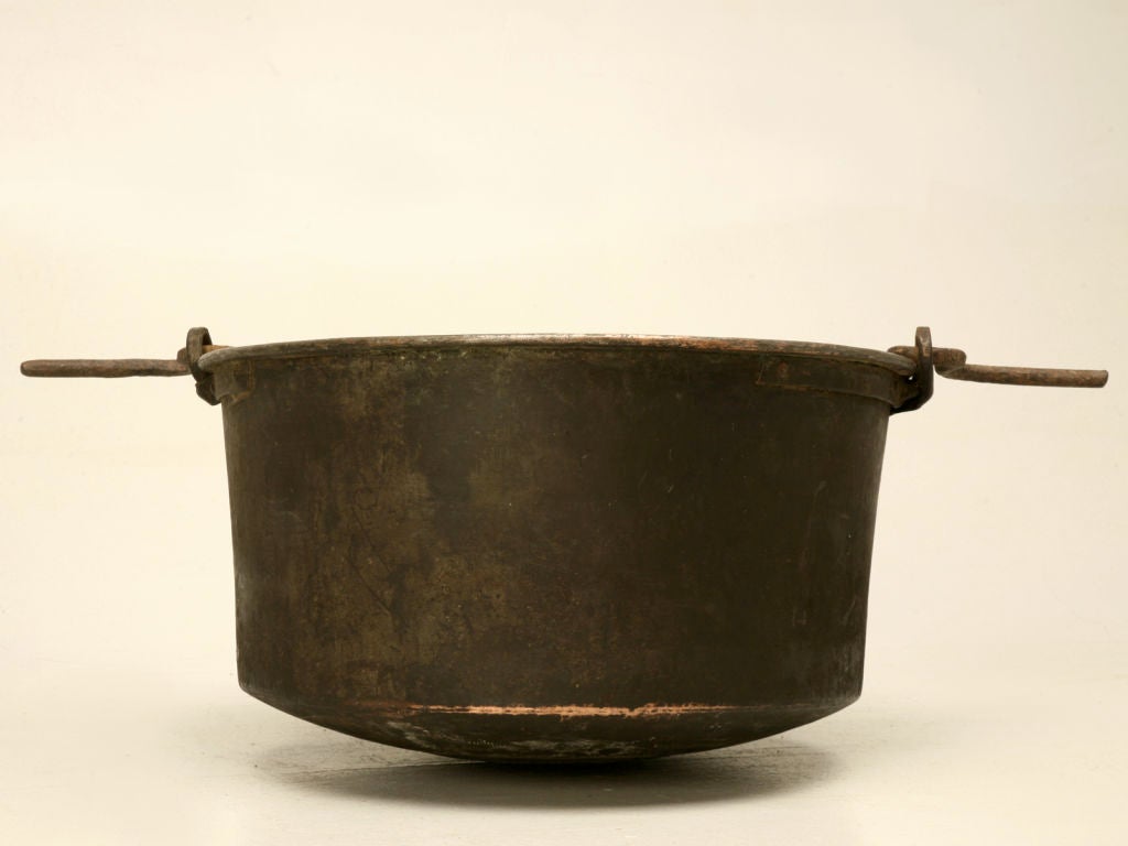 Awesome original antique French handmade copper cauldron with original hand wrought iron bail-form handle. This outstanding vessel retains its original patina from being used over a fire for more than a 100 years. Though it still could be utilized
