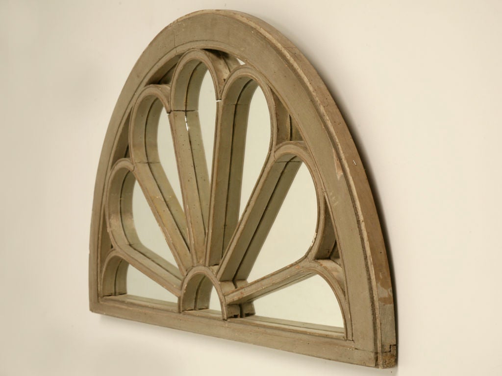 Outstanding antique European painted fan-light arched window expertly crafted into a charming mirror. With it's aged paint and it's fabulous reflective quality, this mirror would look awesome a multitude of places. New mirror in antique fan-light
