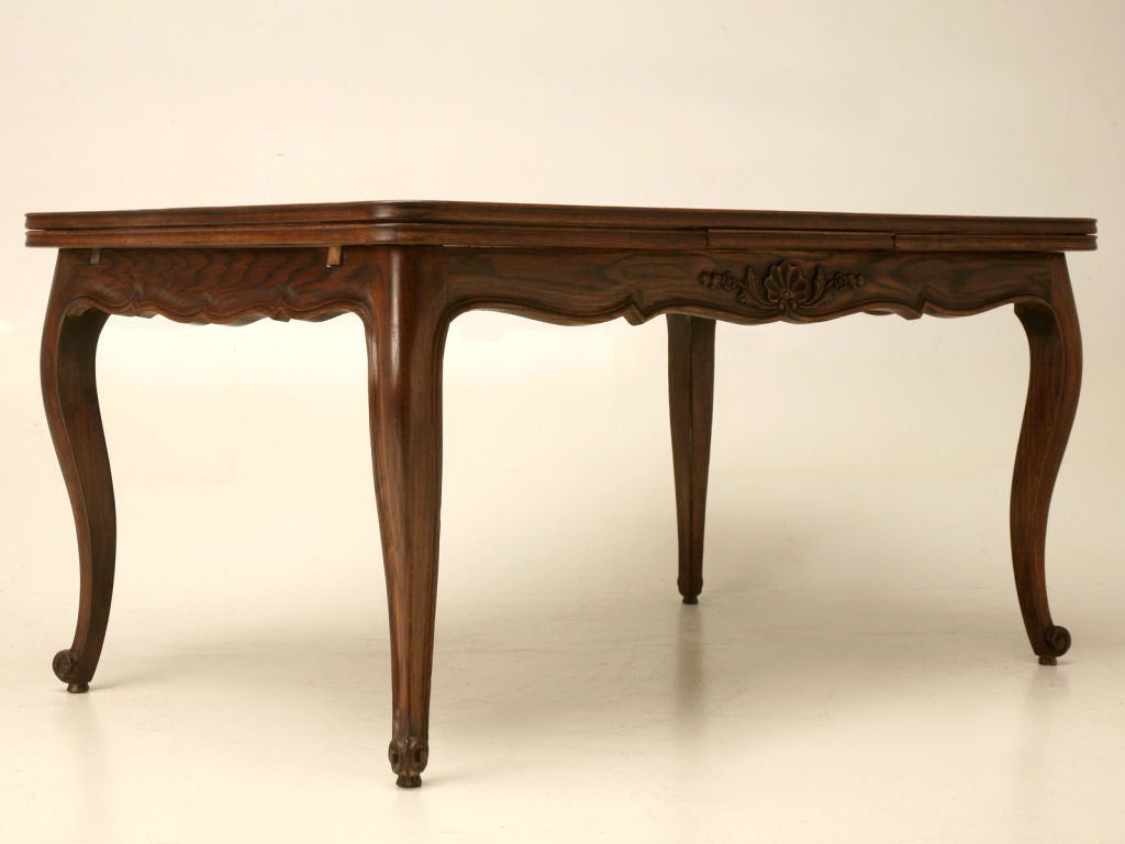 Classic and charming vintage French, Louis XV style,  draw-leaf dining table with a rift-cut (a higher quality cut of wood that makes the figure of the wood more attractive) French white oak parquet top. Petite when closed but hidden leaves slide