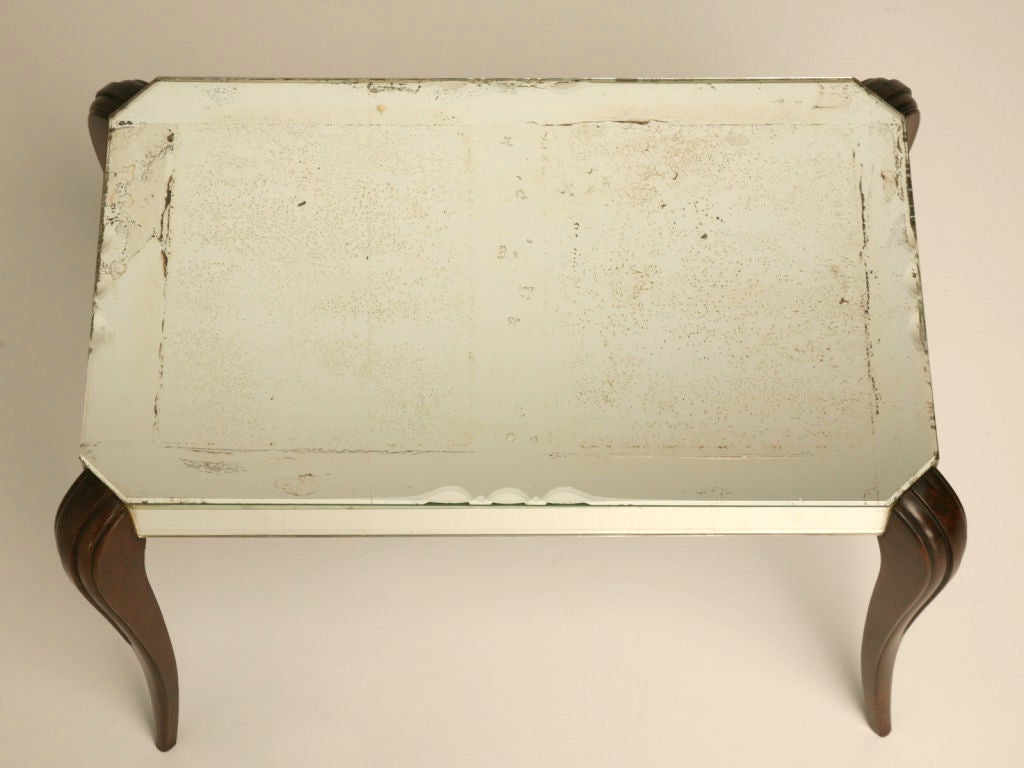 Mid-Century Modern Vintage French Mirrored Coffee or Cocktail Table with oak legs, retaining all of its original mirror, the Coffee Table top is scalloped on all four sides. The entire piece has a beautiful patina. Fluid uncluttered lines make