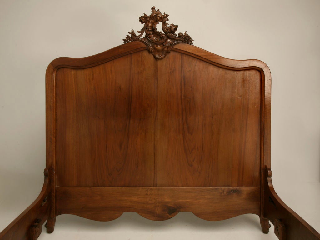 Absolutely stunning, structurally strong, antique French walnut bed with outrageous hand-carved details. Beautiful utilized in a guest suite, or possibly modified into a king size headboard(call for details) for the master suite.<br />
<br />
*