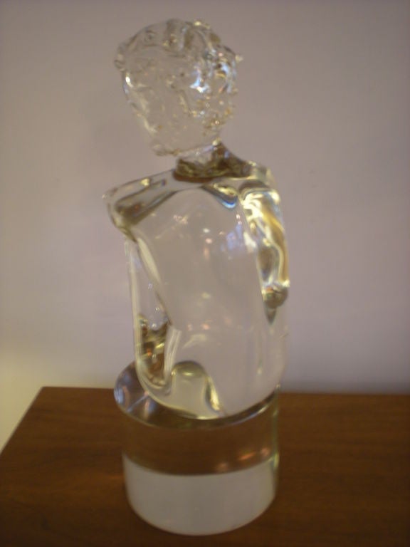 Young wavy-hair boy sitting glass sculpture. Very smooth finish.<br />
There is a big signature but very difficult to read.