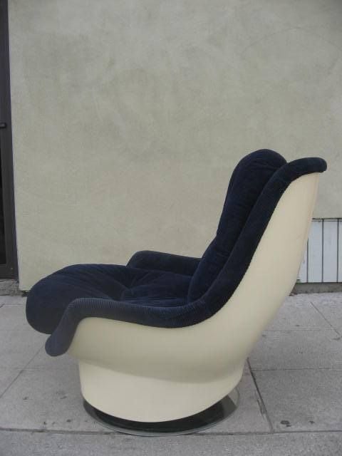 Super cozy fiberglass chair upholstered in a soft blue corduroy.  Seat is at a reclined angle for extra comfort and support.  Chair swivels and sits on chrome base.