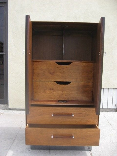 Tall boy with slatted rosewood cabinet doors that open to shelving space and two drawers. Bottom drawers are walnut with rosewood and chrome hardware.  Chrome base.