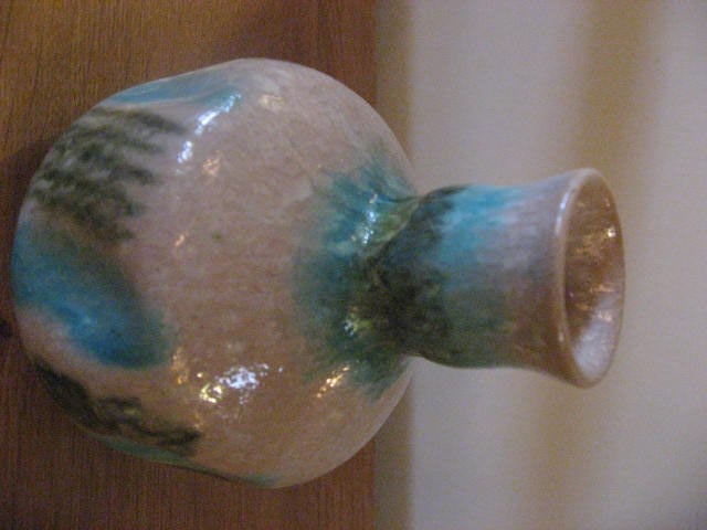 Italian and Mid-Century small vase with turquoise, green and white accents has glazed finish and soft lines.