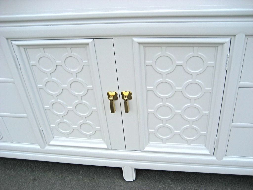 Gorgeous Modern credenza with Oriental brass hardware freshly refinished in white lacquer.