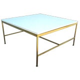 Brass coffee table with white glass top by Paul McCobb