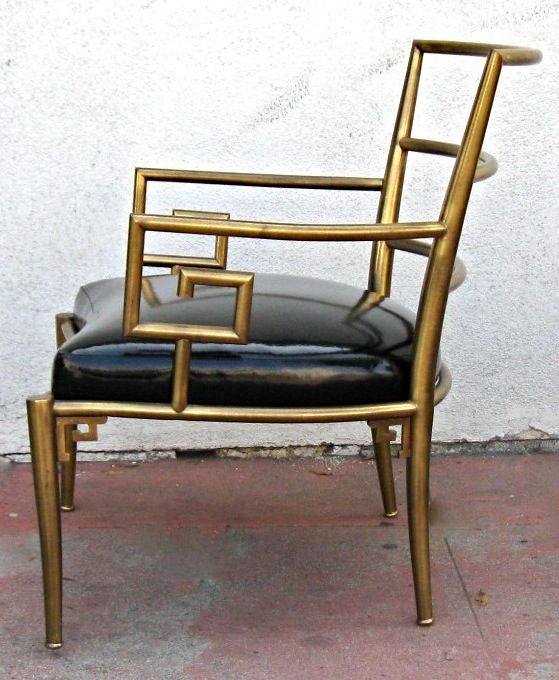 Beautifully crafted brass chair with Greek key armrests and black Patent leather upholstery.  This chair was made in Italy for Mastercraft of Grand Rapids.