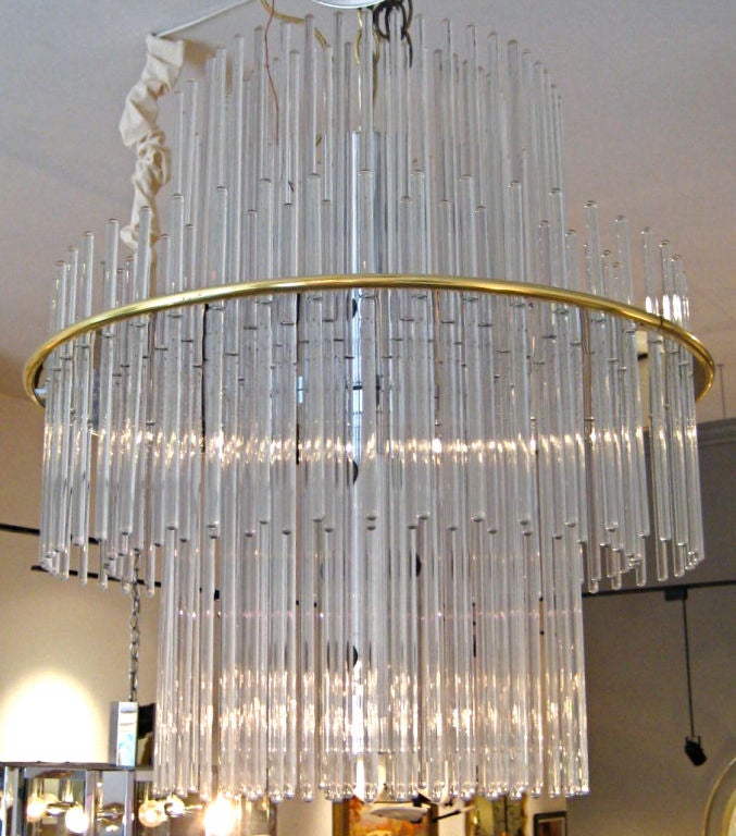 Varying lengths of glass Rods hung from a brass framed Chrome fixture form this fabulous Waterfall form Chandelier.