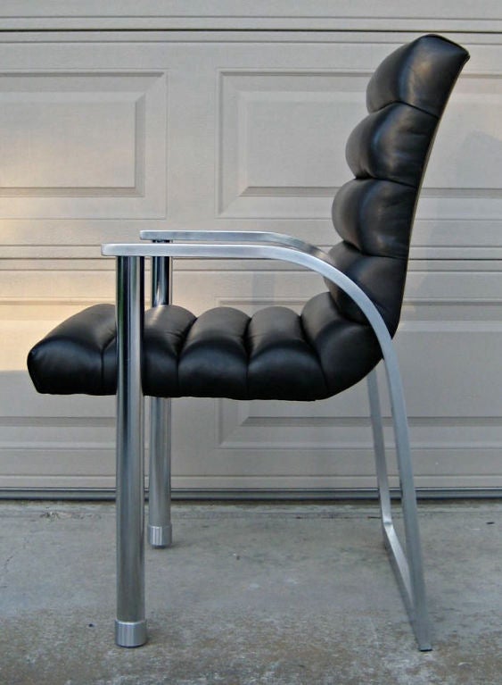 Pair of Jay Spectre Eclipse Lounge Chairs with Black Leather upholstery.  Frames are brushed stainless steel with polished steel front legs.