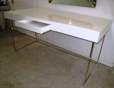 Square metal Frame in a nickel finish , top surface lacquered wood in a hi-gloss white finish , or it could be re-done if you provide us with a color of your choice. This is inclusive in the price of desk.